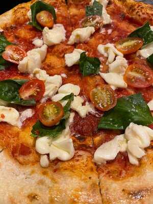 Pizza with tomato, basil, and cheese